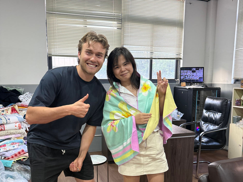 Vick's son giving a thumbs up at the factory with our agent in China, who is wrapped in an Actv8 towel