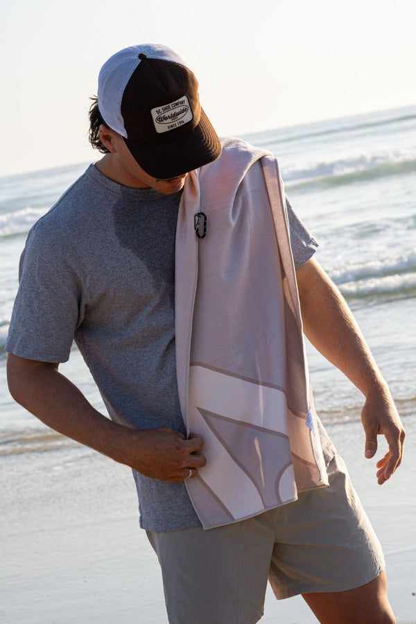 Hoodless Gym Towel in Lume over the shoulder at the beach