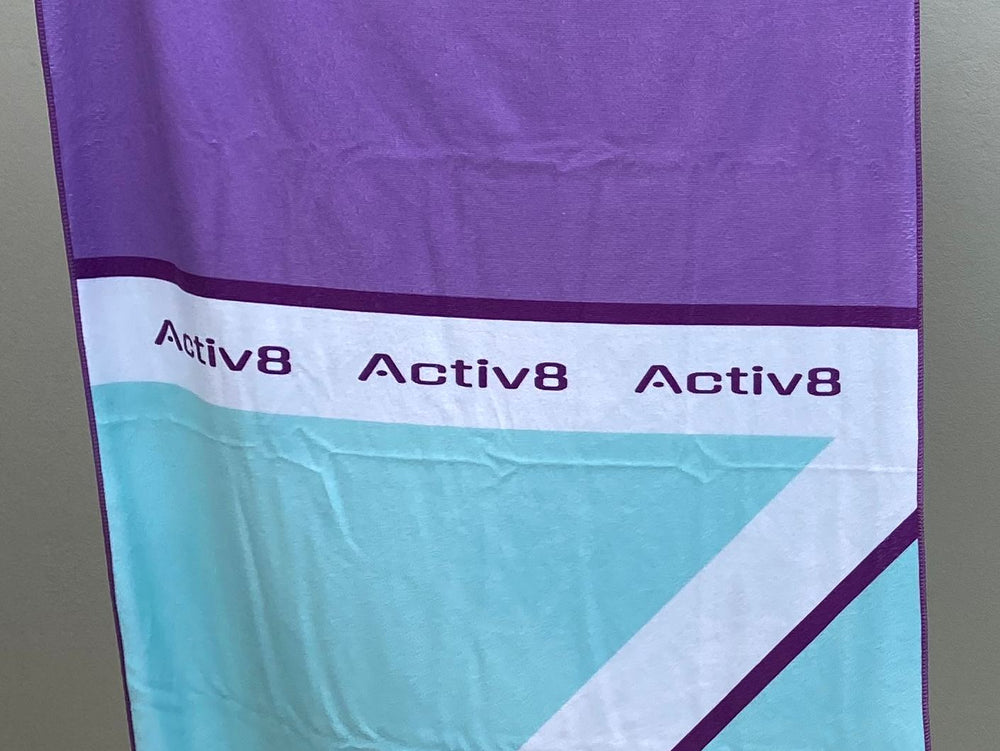 An early printed purple and aqua prototype towel hanging on the line