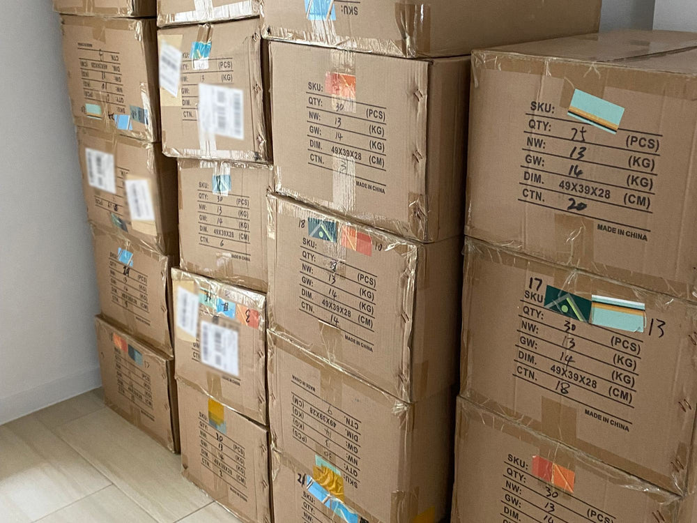 Cartons of stock stacked high in a room at home